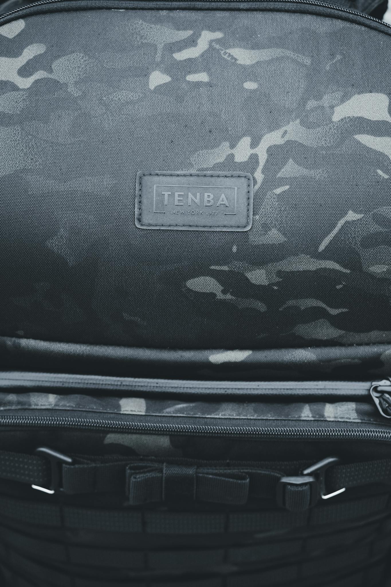 Detailed view of a Tenba brand backpack featuring a stylish camouflage pattern.