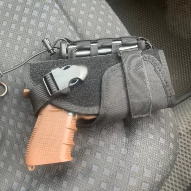 Universal tactical holster for a pistol, with MOLLE attachment, black